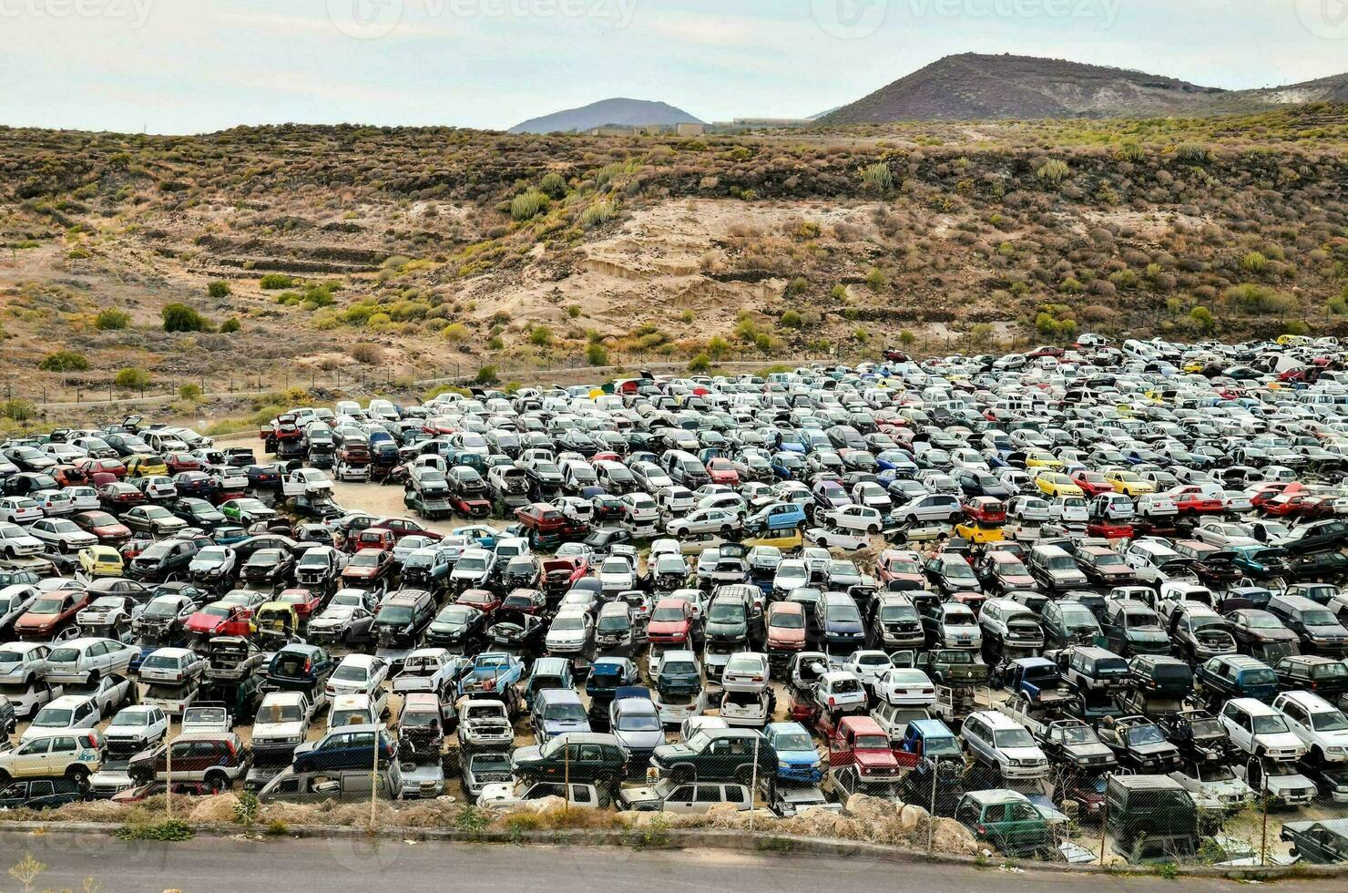 a large pile of cars in a desert photo