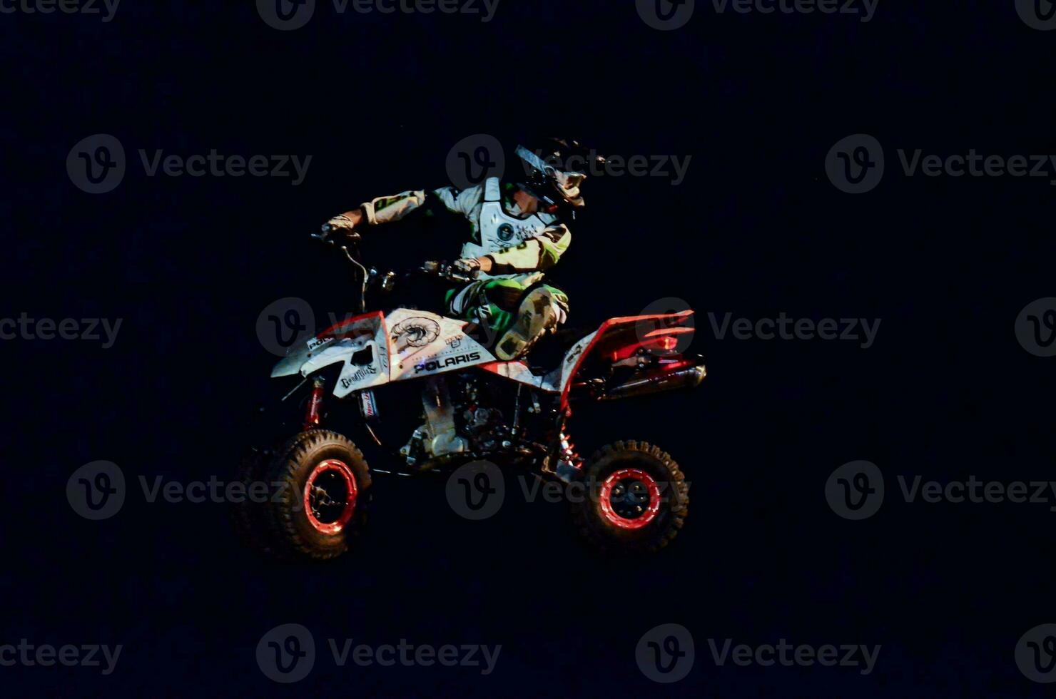 a man on a quad bike in the dark photo