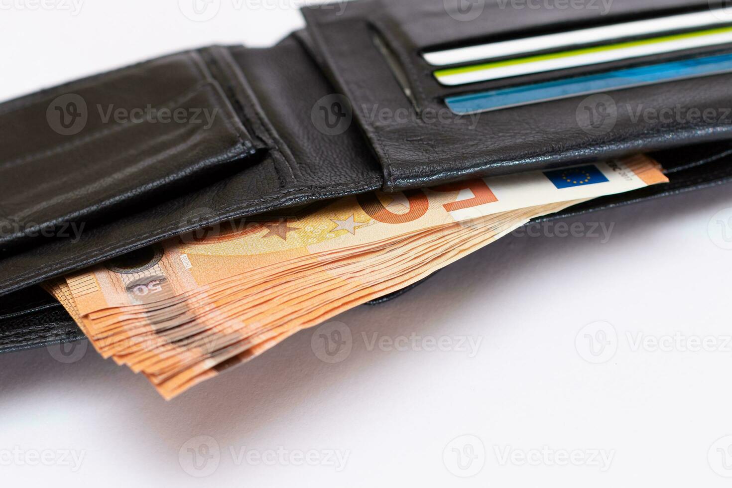 Opened Black Leather Men Wallet with Fifty Euro Banknotes and Bank Cards Inside on White Background. A Purse Full of Money and Credit Cards Symbolizing Wealth, Success and Social Status photo