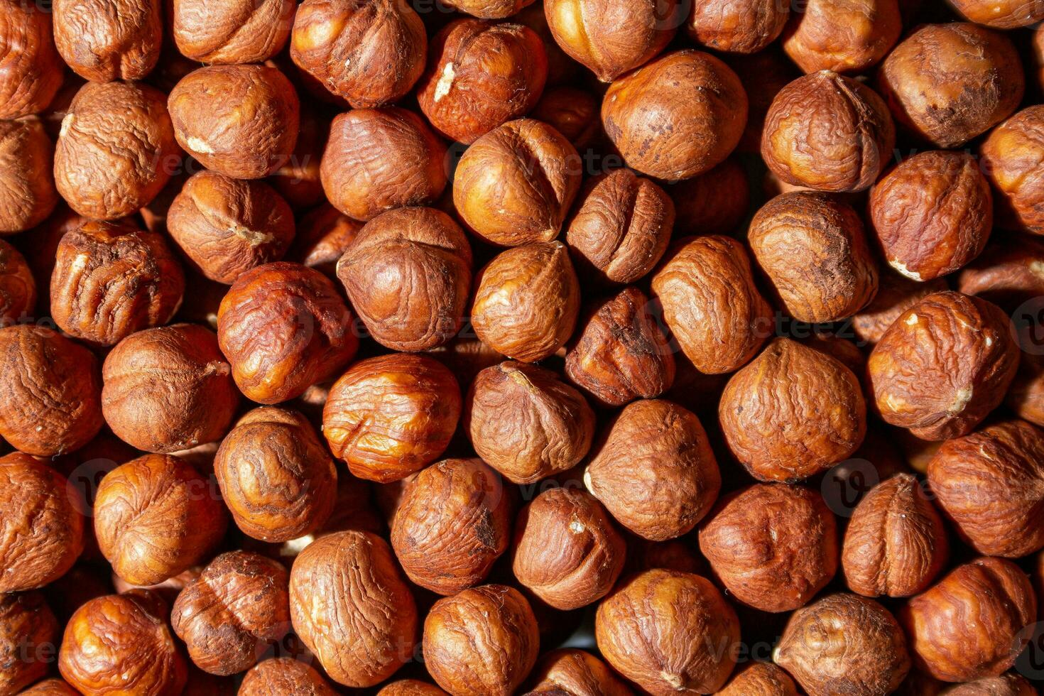 Scattered Peeled Hazelnut - Top View. Background from Hazelnuts. Natural High-Calorie Snacks photo