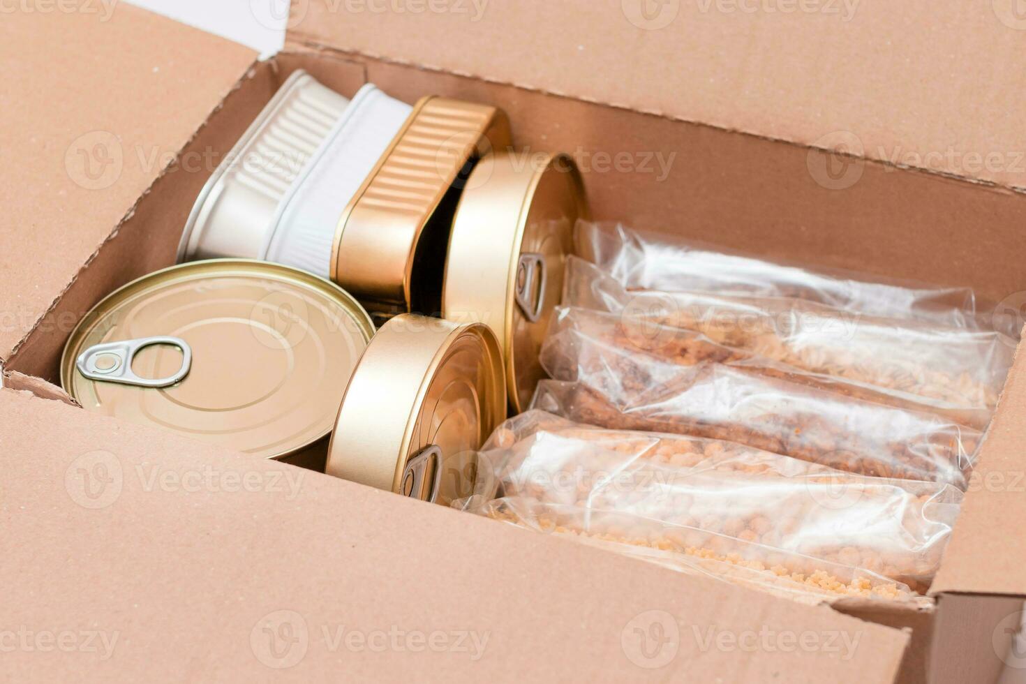 Food Reserves or Donation Box. Carton Box with Canned Food, Cereals and Grocery. Emergency Food Storage in Case of Crisis. Free Social Help, Blessings and Care. Strategic Food Supplies photo