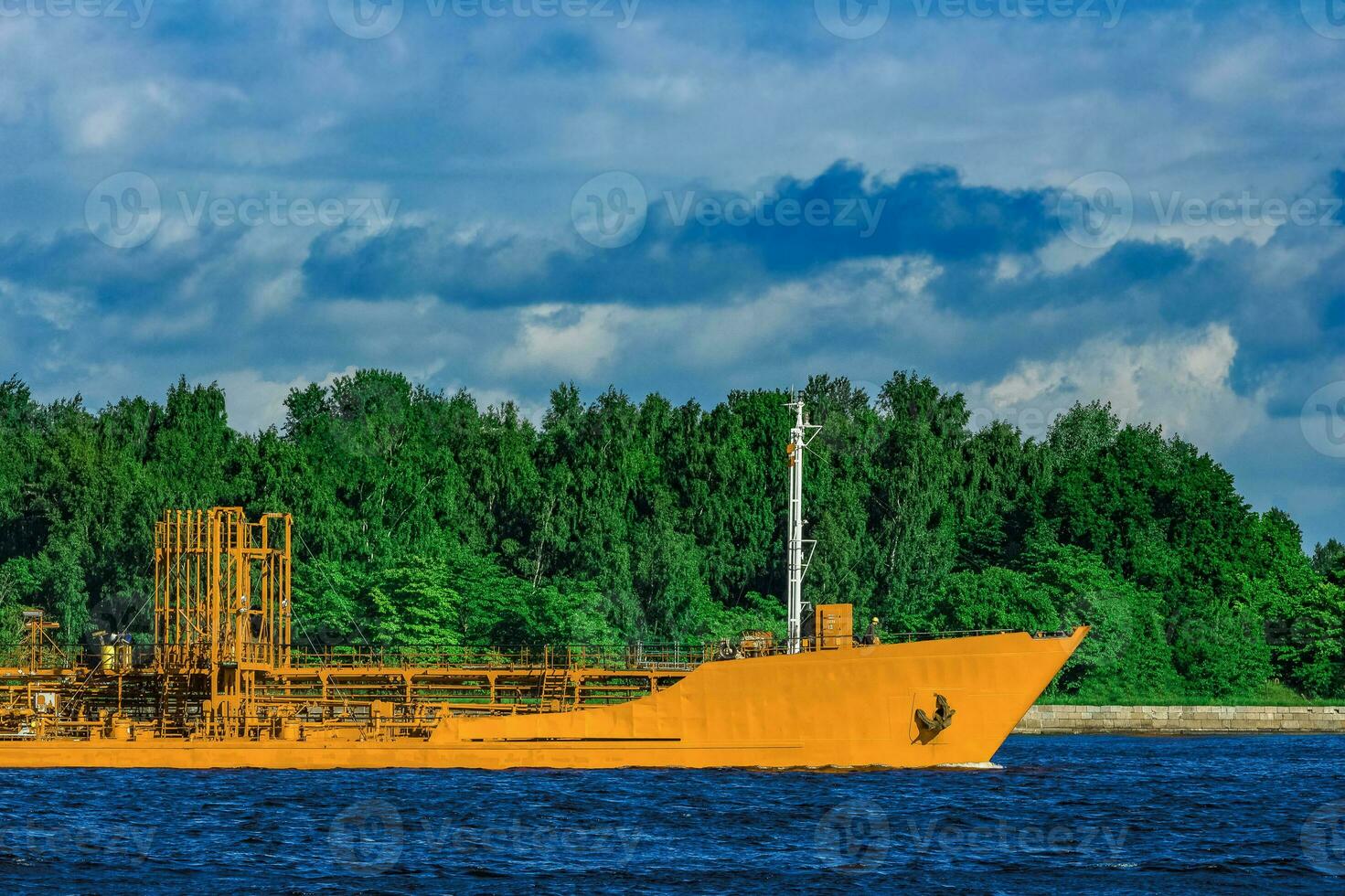 Yellow cargo tanker ship moving at the clear summer day photo