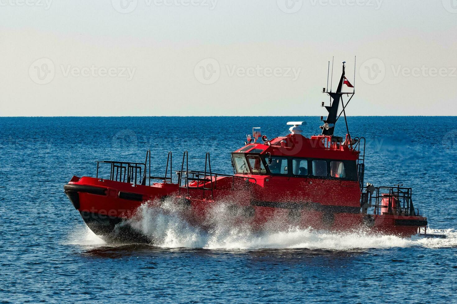 Red pilot ship moving from the Baltic sea photo