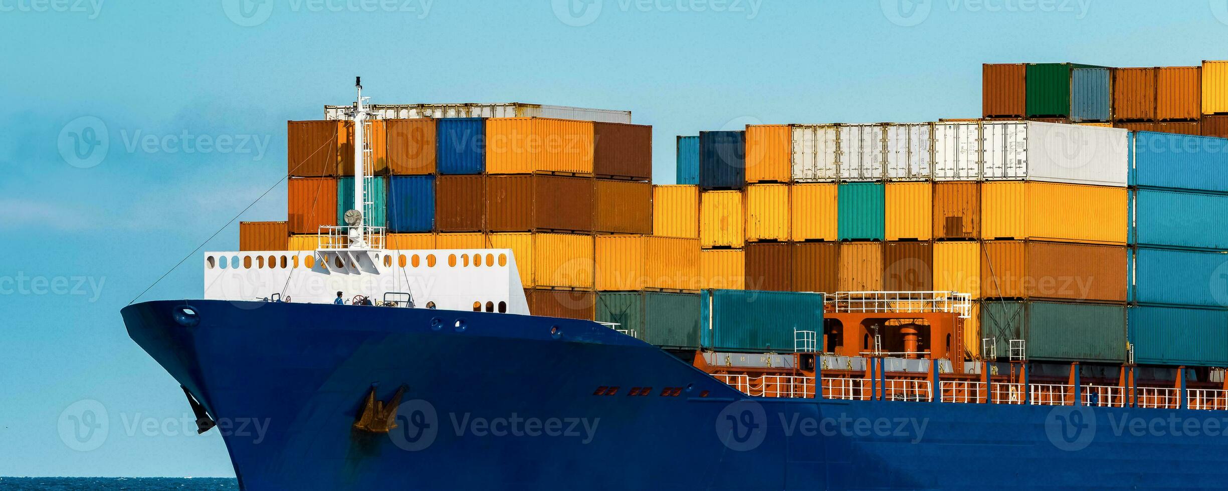 Blue container ship in travel. Logistics and freight industry photo