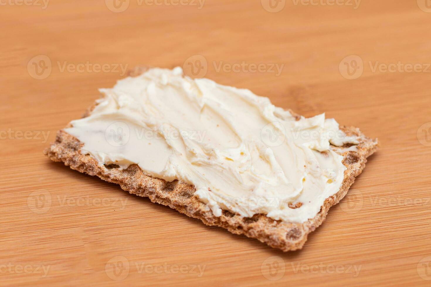 Whole Grain Crispbread with Cream Cheese on Bamboo Cutting Board. Quick and Healthy Sandwiches. Healthy Dietary Snack photo