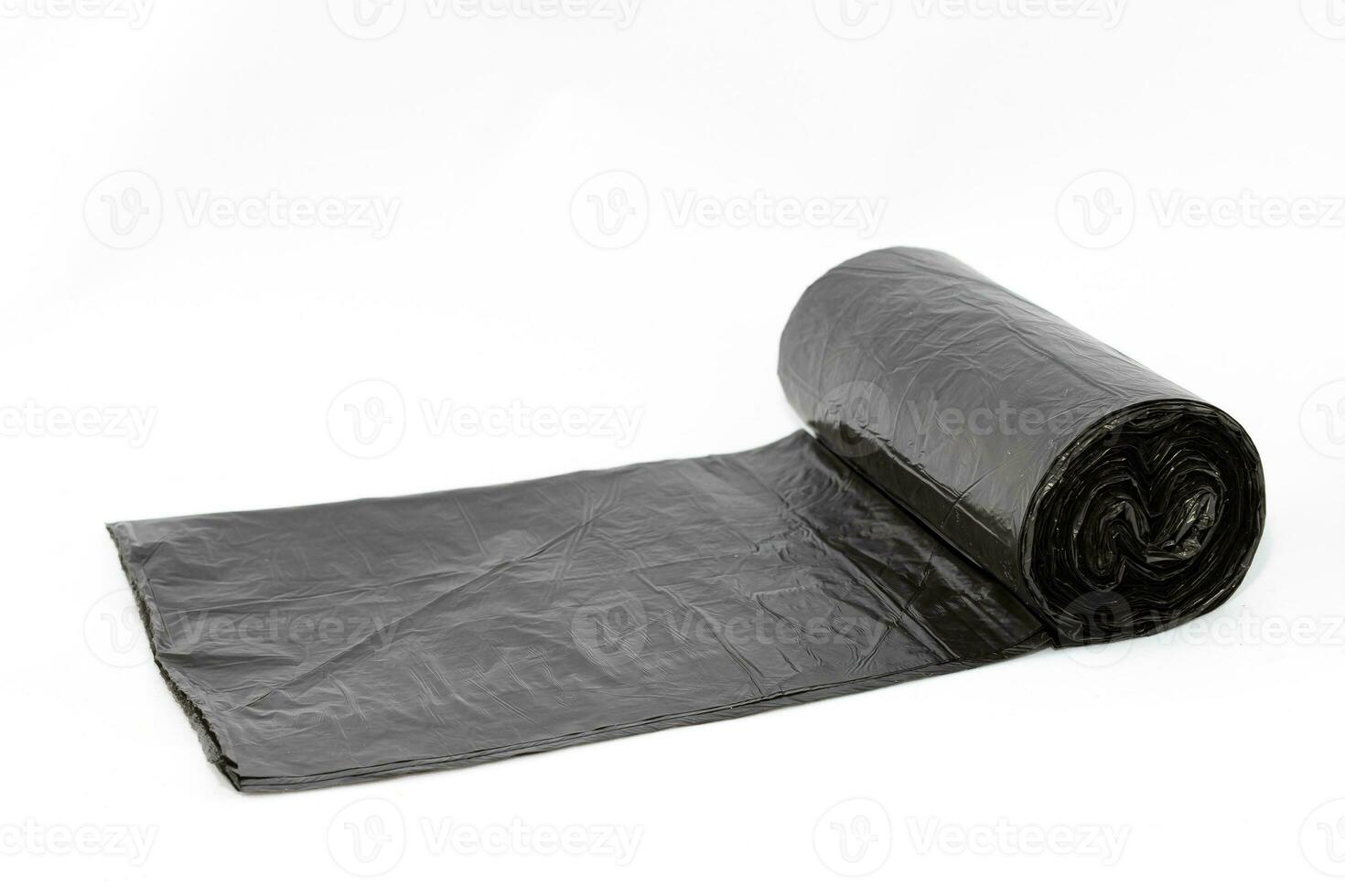 Black Polyethylene Garbage Bags on White Background CloseUp. The Roll of Plastic Junk Package photo