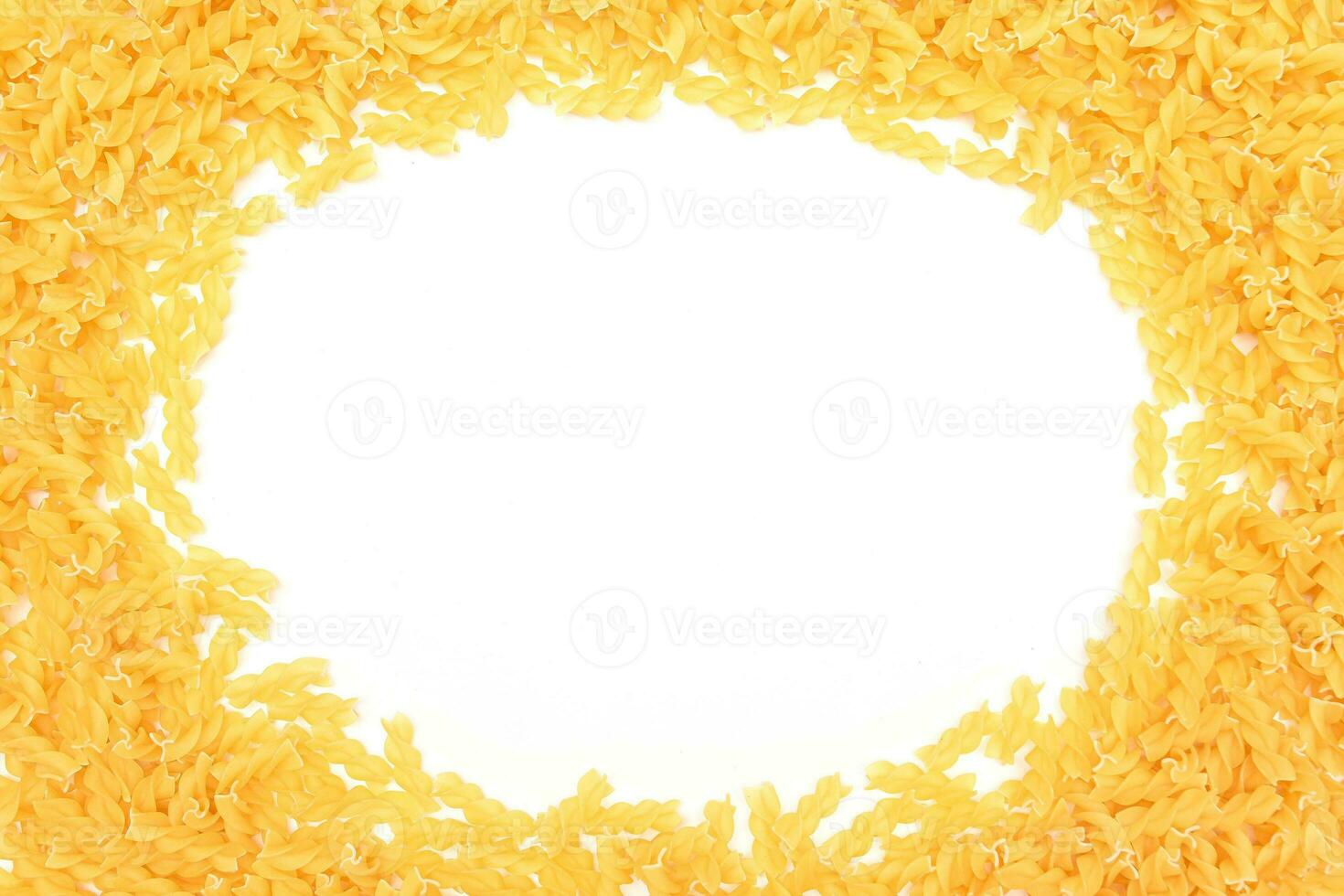A Frame Made from Uncooked Fusilli Pasta Scattered on White Table Mock Up. Raw and Dry Macaroni. Unhealthy and Fat Food. Italian Culture photo