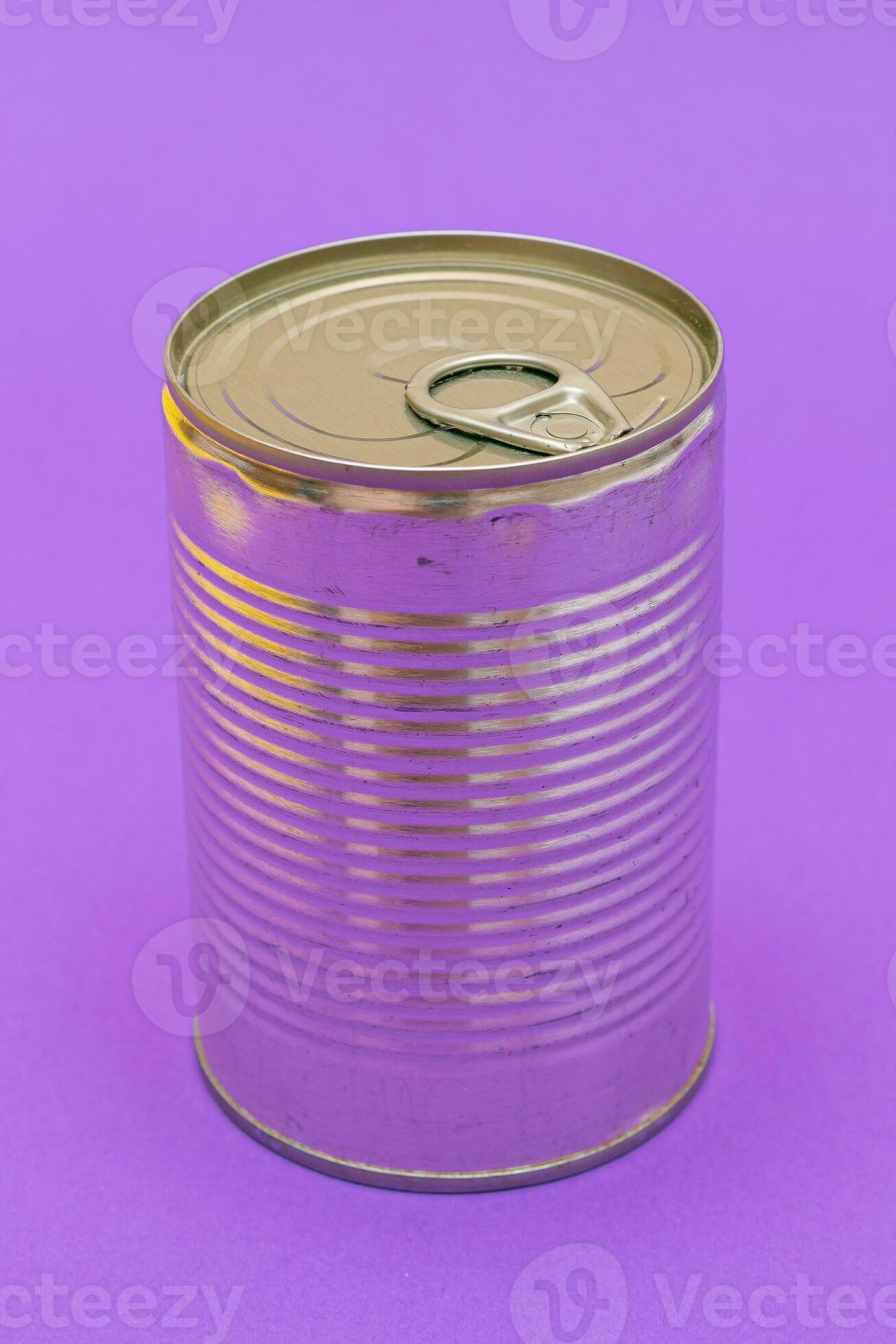 Unopened Tin Can with Blank Edge on Violet Background. Canned Food