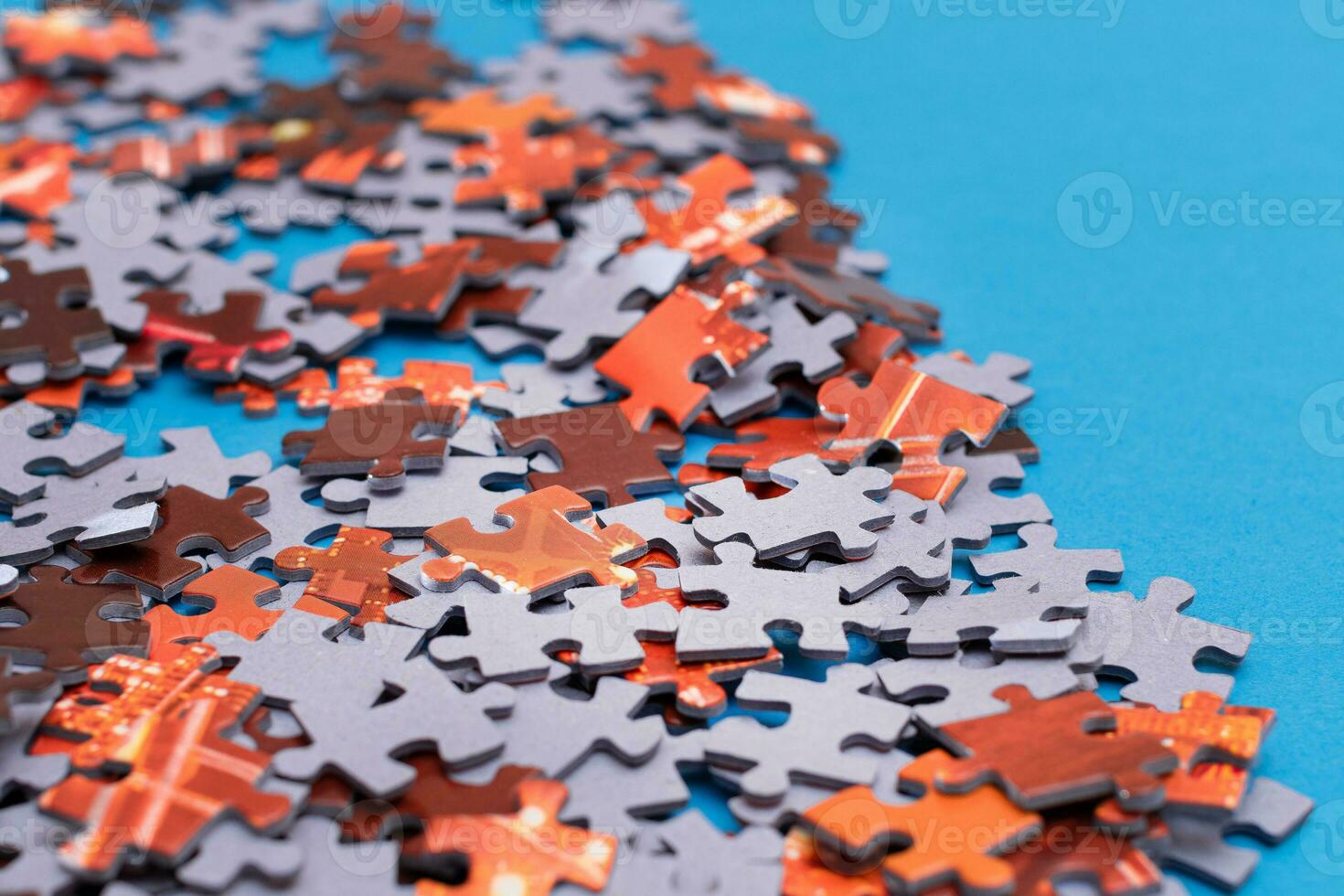 Mixed Peaces of a Colorful Jigsaw Puzzle Lie on the Blue Background Strategy and Solving Problem Concept photo