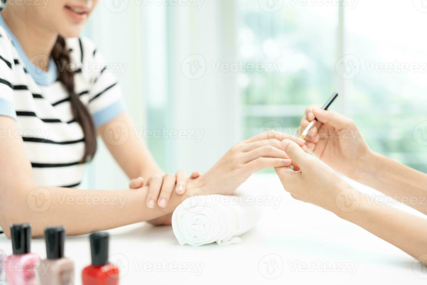 Woman receive care service by professional Beautician Manicure at spa centre. Nail beauty salon use nail file for Glazing treatment. manicurist make nail customer to beautiful. body care spa treatment photo