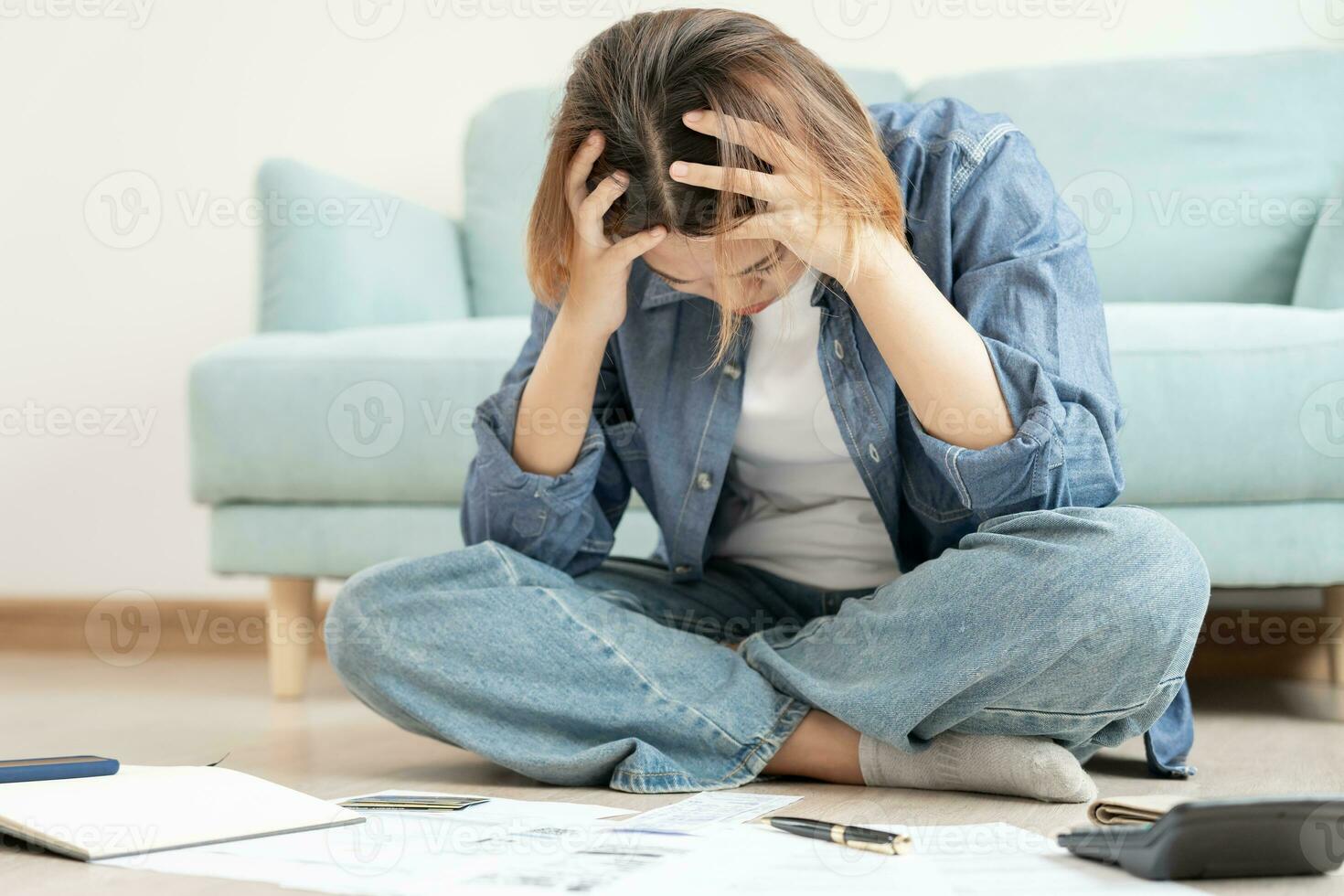 Stressed and headache asian woman with large bills or invoices no money to pay to expenses and credit card debt. shortage, Financial problems, mortgage, loan, bankruptcy, bankrupt, poor, empty wallet photo