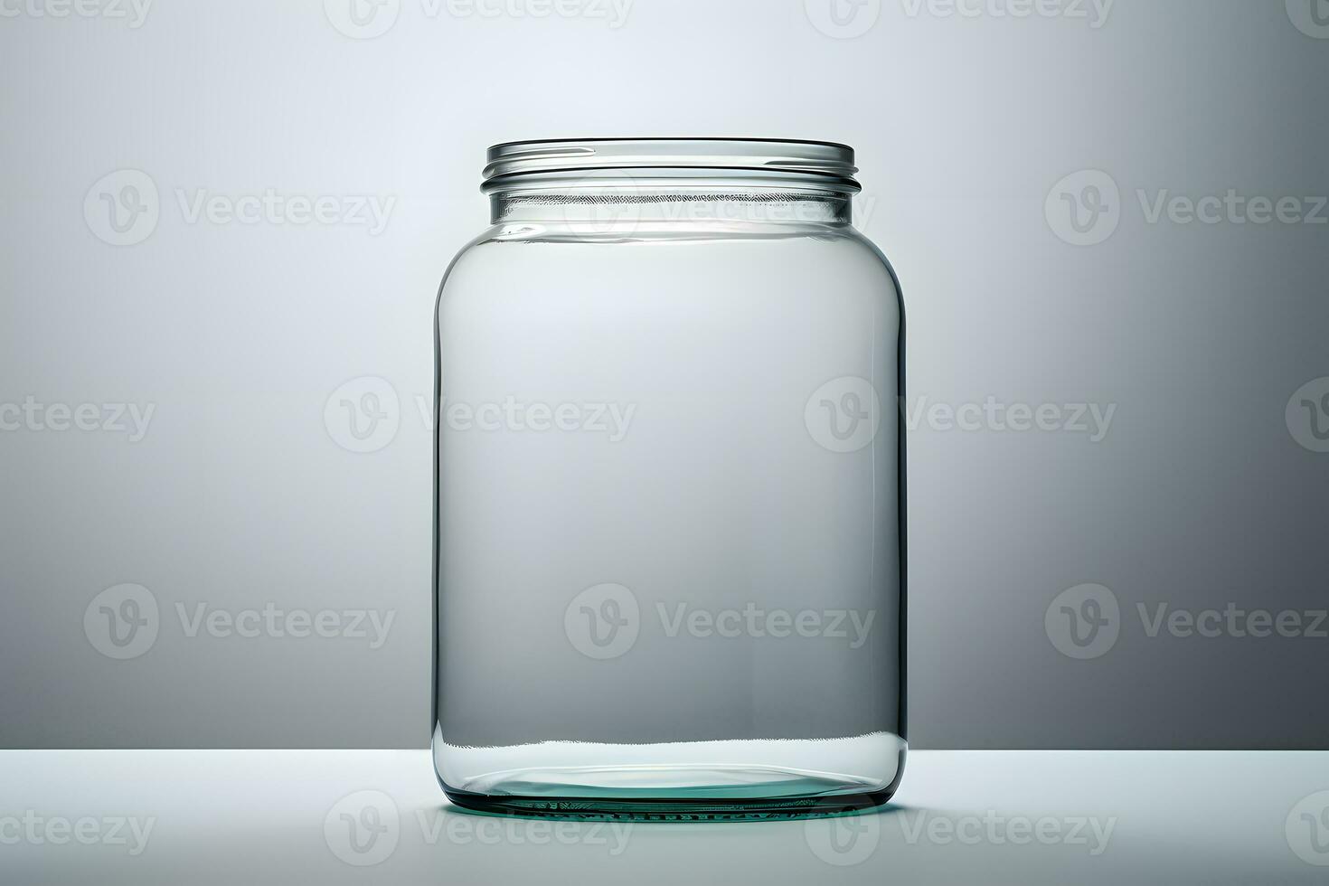 Empty glass jar on gray background photo