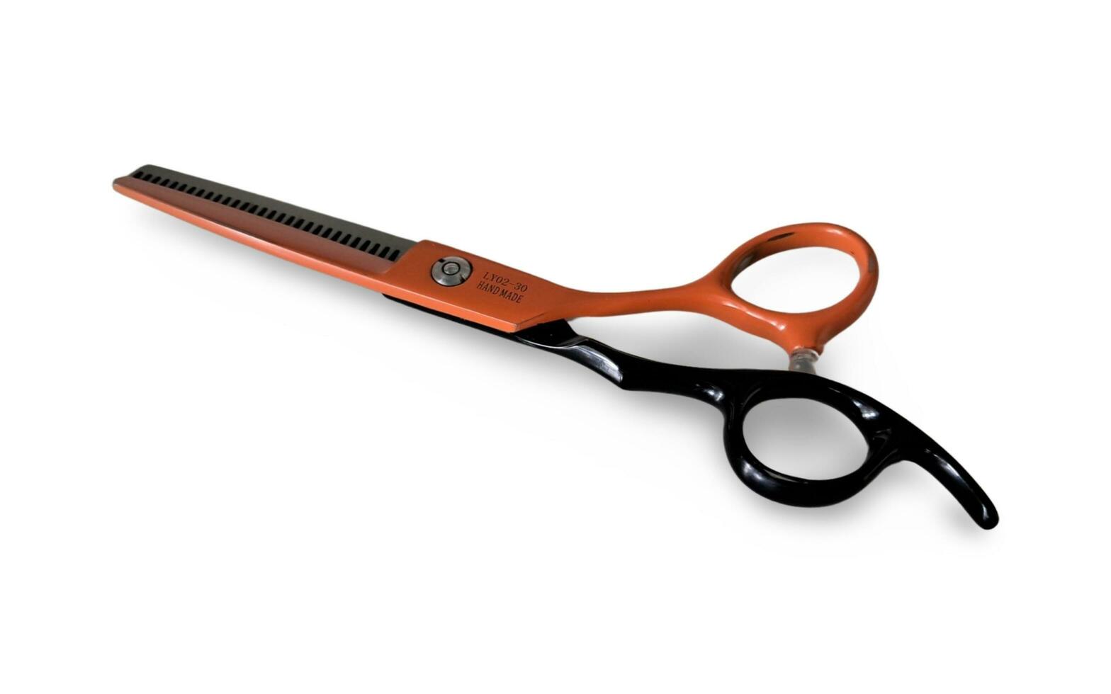 a pair of scissors with orange handles on a white background photo