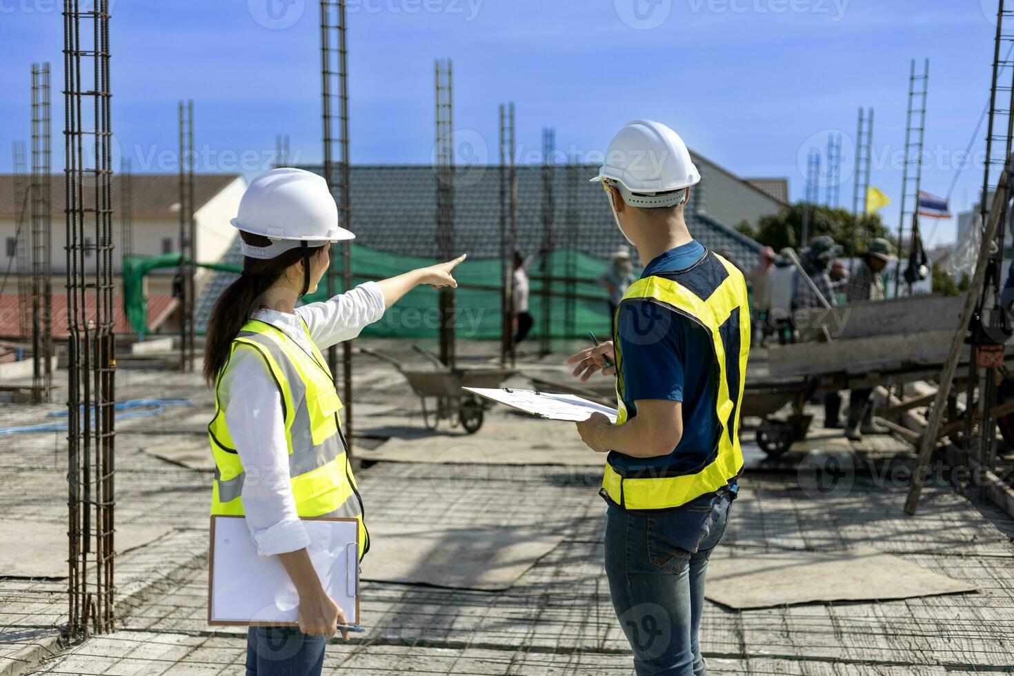 Team of engineering architect inspector and contractor having discussion while examining the quality of construction work of real estate development project photo