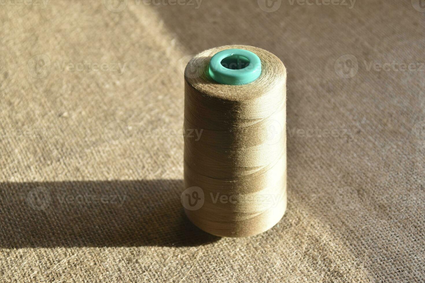 Skeins of thread on burlap. Yellow threads on coarse cloth. photo