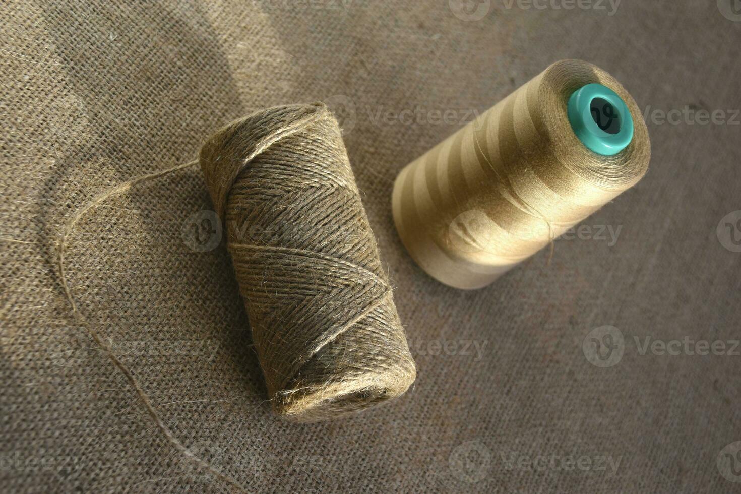 Skeins of thread on burlap. Yellow threads on coarse cloth. photo
