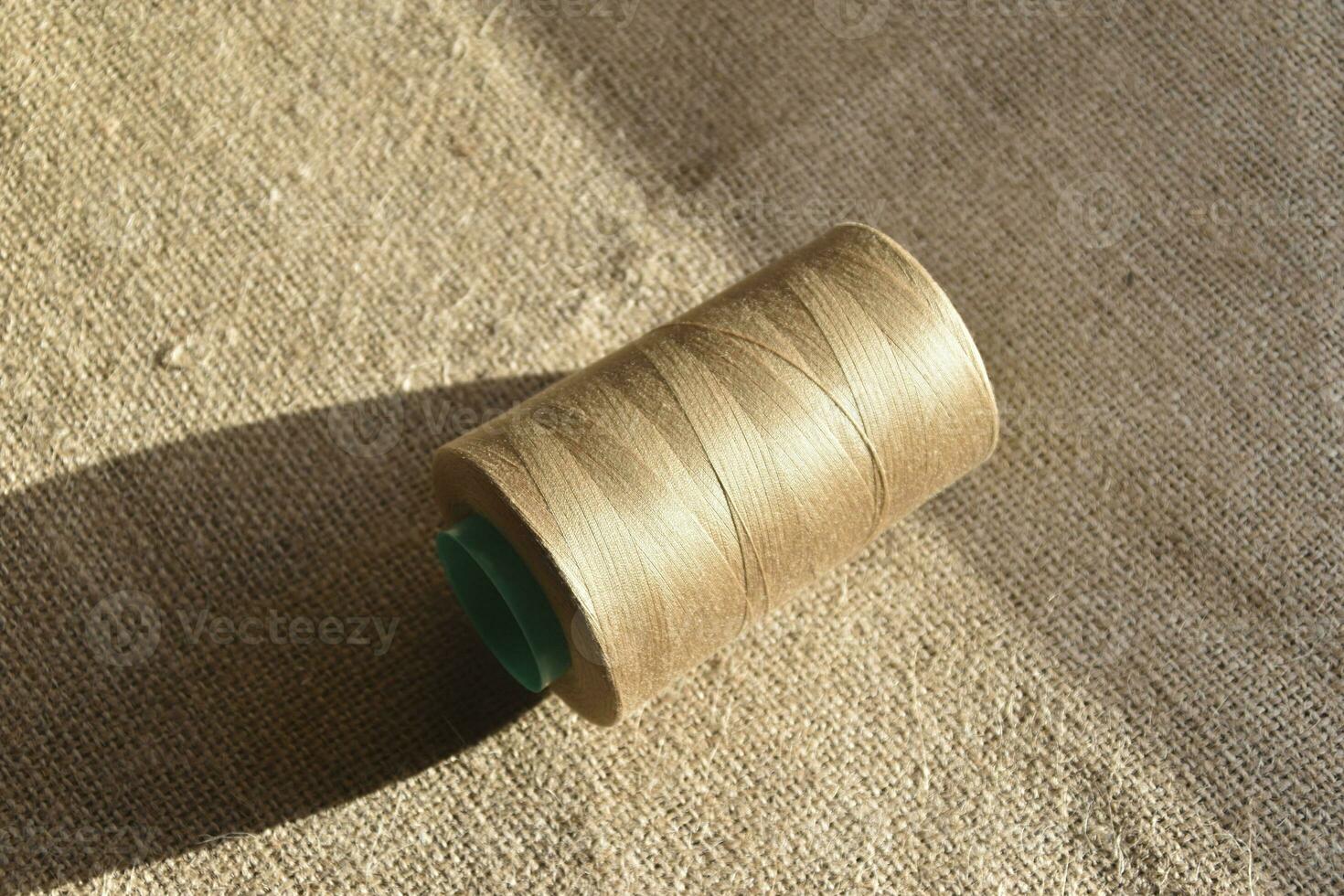 Skeins of thread on burlap. Yellow threads on coarse cloth. photo