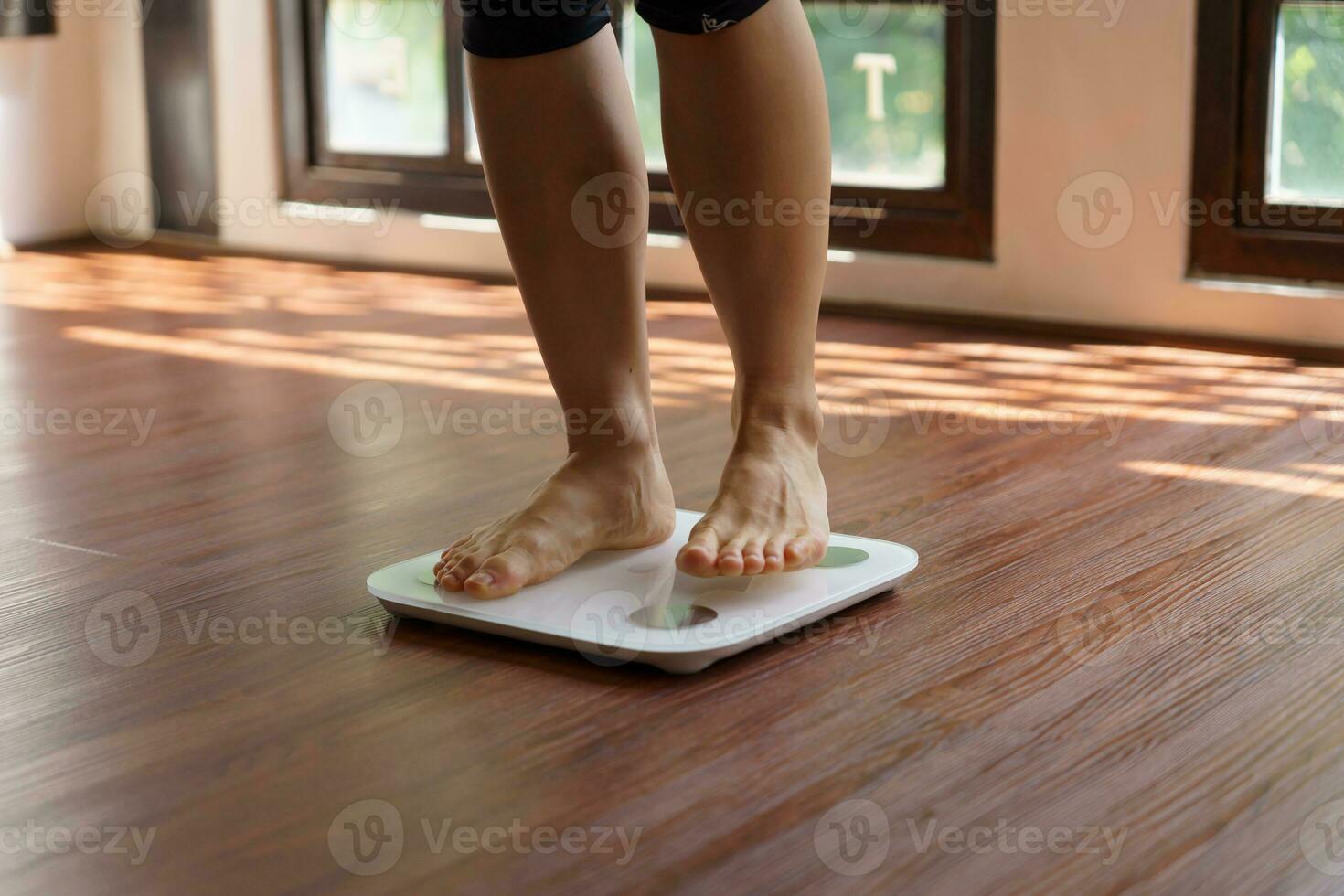 Fat diet and scale feet standing on electronic scales for weight control. Measurement instrument in kilogram for a diet control photo