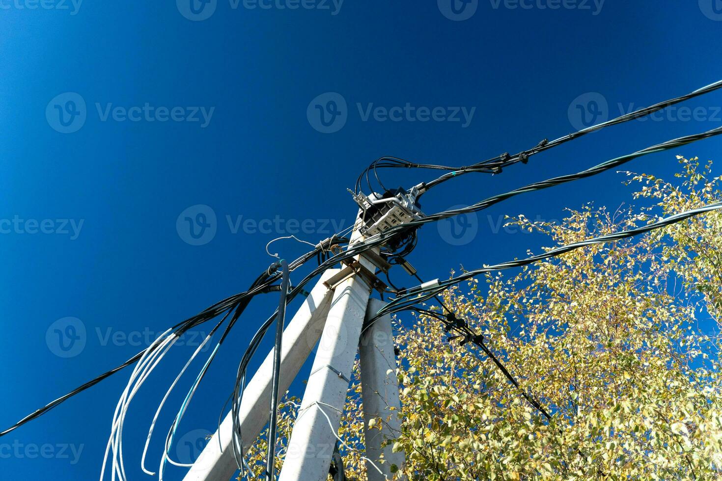 Tall Concrete Pillar Supporting Electrical Power Supply Wires photo