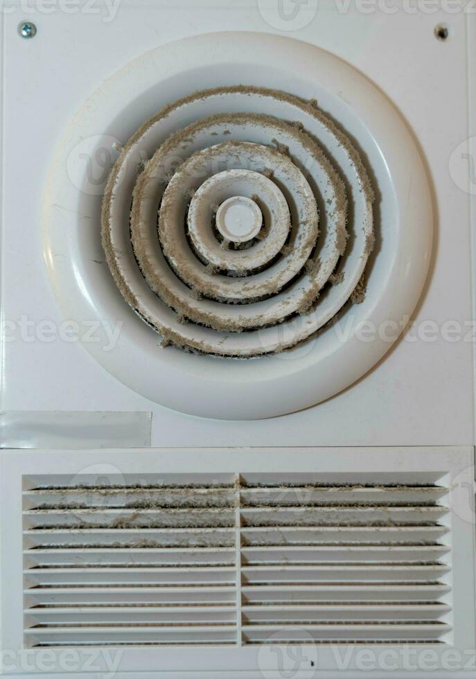 Dirty and Dusty Electric Duct Fan in Bathroom Extractor Hood Needs Cleaning for Proper Ventilation photo