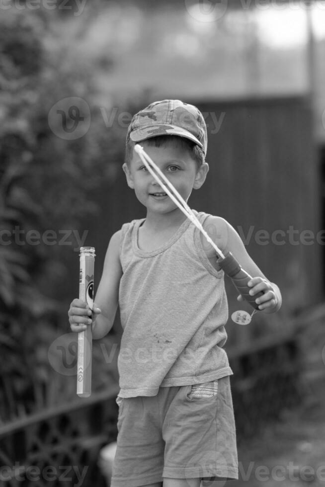 Beautiful baby boy with child soap bubbles posing photographer for cool photo