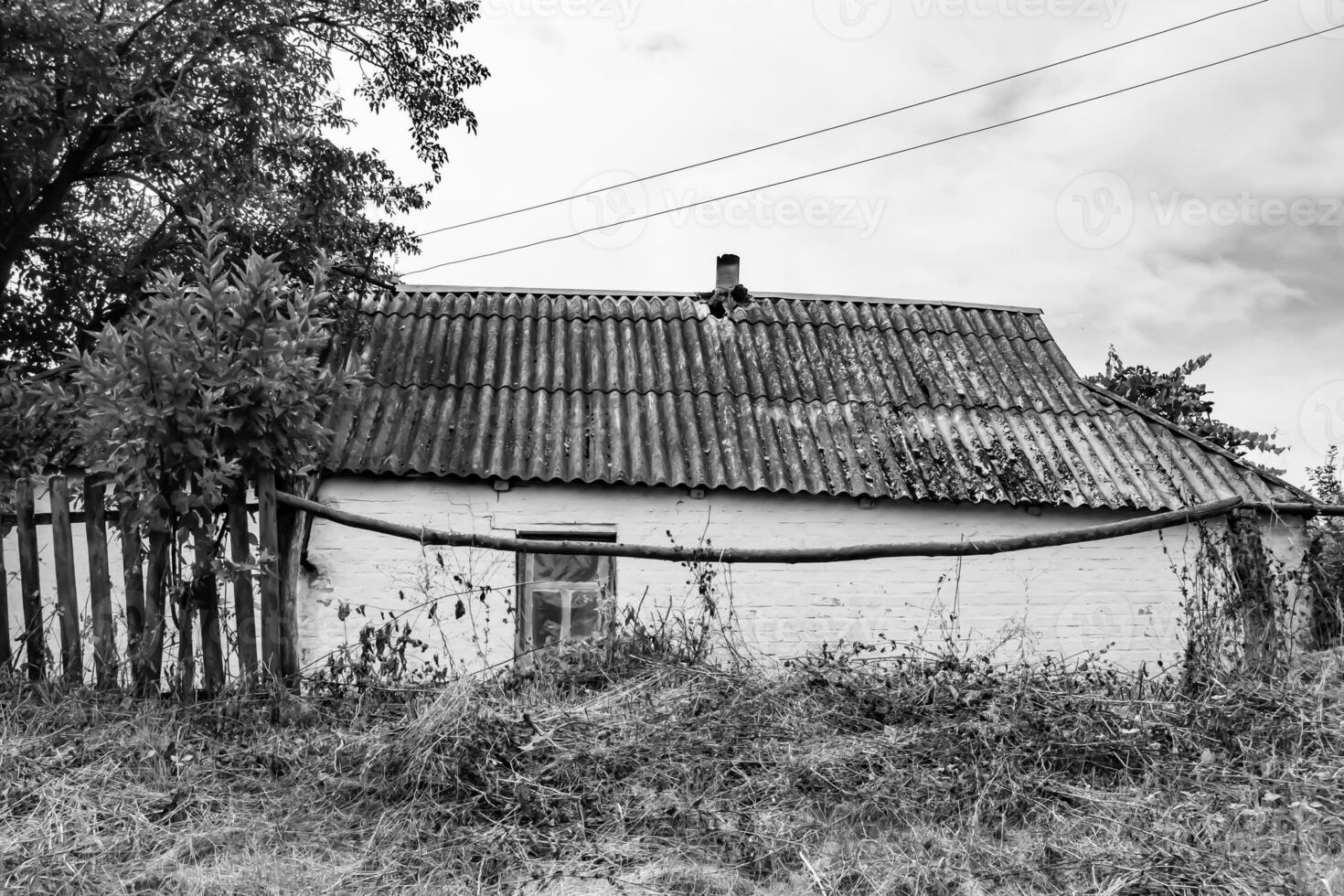 Beautiful old abandoned building farm house in countryside on natural background photo