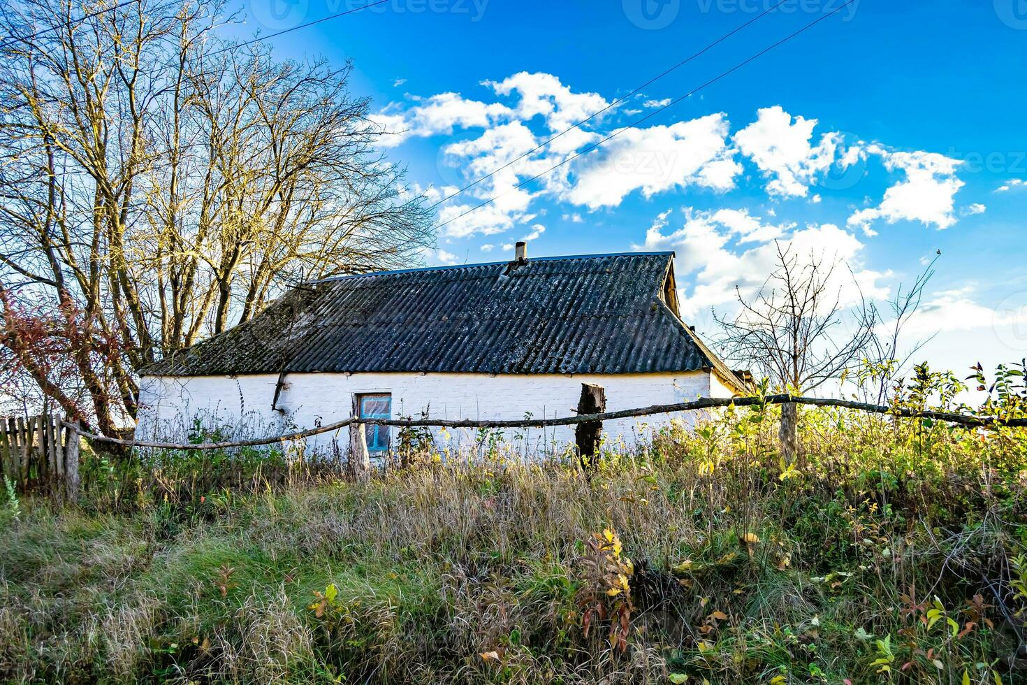 Beautiful old abandoned building farm house in countryside on natural background photo