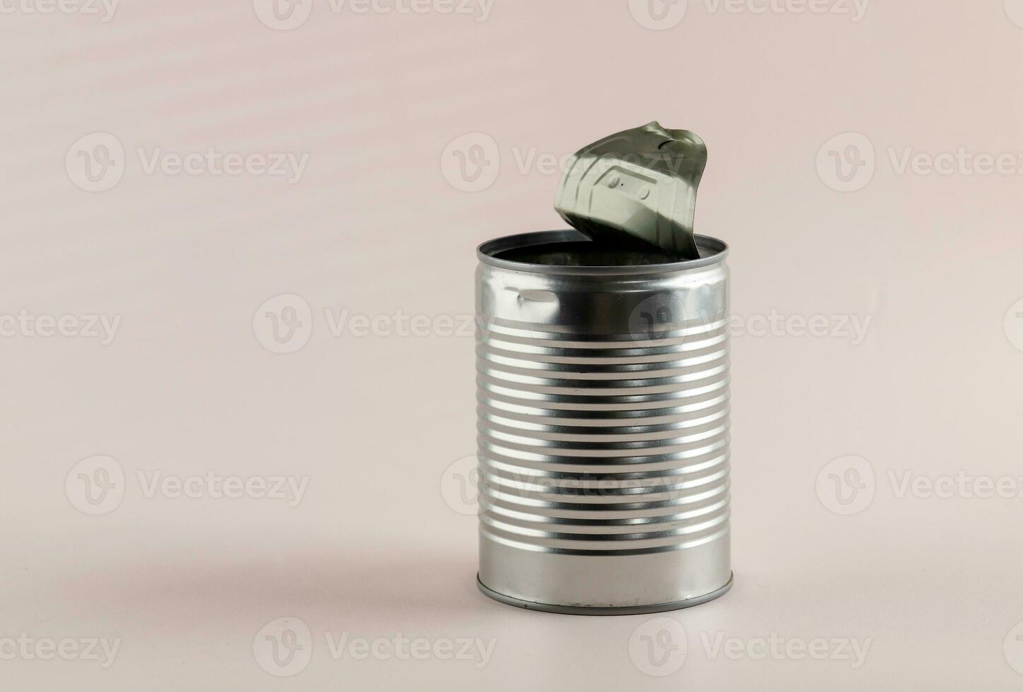 Empty Food Can Opened on Pink Background photo