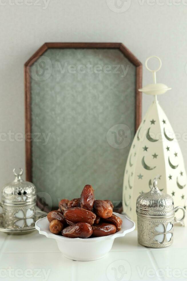 Cup of Tea and Dry Dates Kurma Ready to Eat for Iftar Time. photo