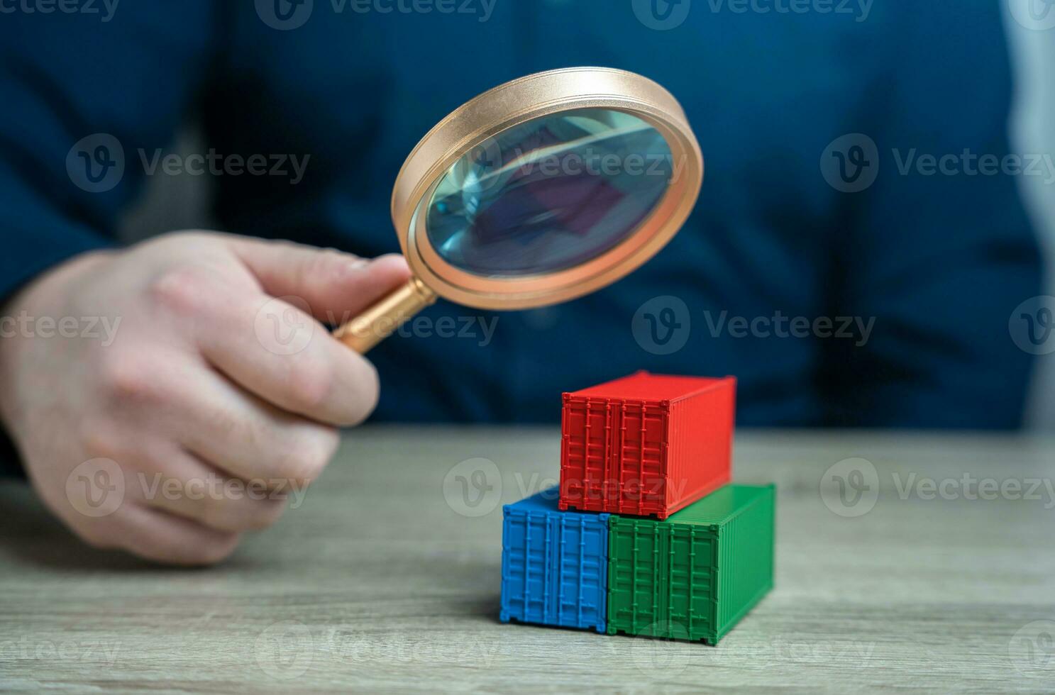 Examining cargo containers through a magnifying glass. Studying the origin of goods and delivery routes. Counteraction to circumvention of sanctions, transportation of drugs and prohibited goods. photo