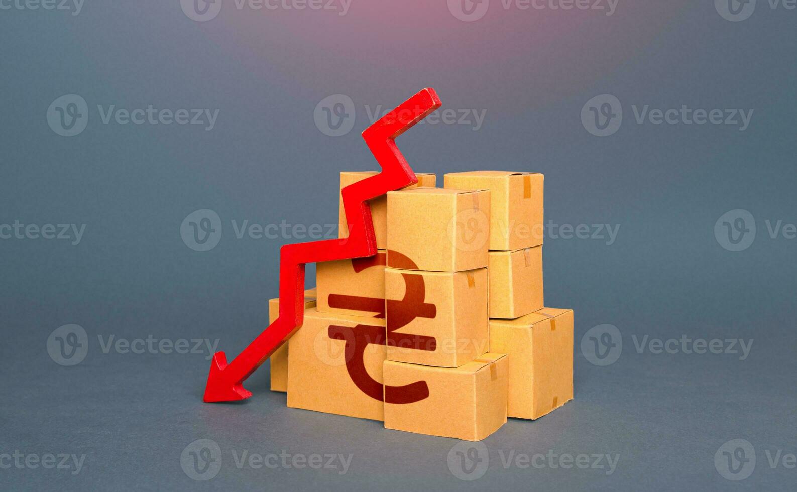 Boxes with ukrainian hryvnia symbol and arrow down. Decrease in stocks of products. Fall in goods production. Embargo, sanctions. Low consumption. Economic slowdown. Price reduction. Worsening trade. photo