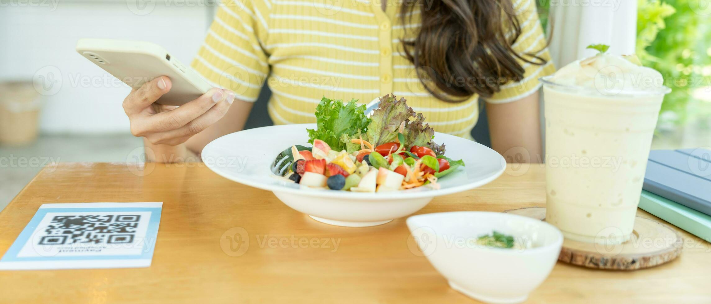 Woman use smartphone to scan QR code to pay in cafe restaurant with a digital payment without cash. Choose menu and order accumulate discount. E wallet, technology, pay online, credit card, bank app. photo