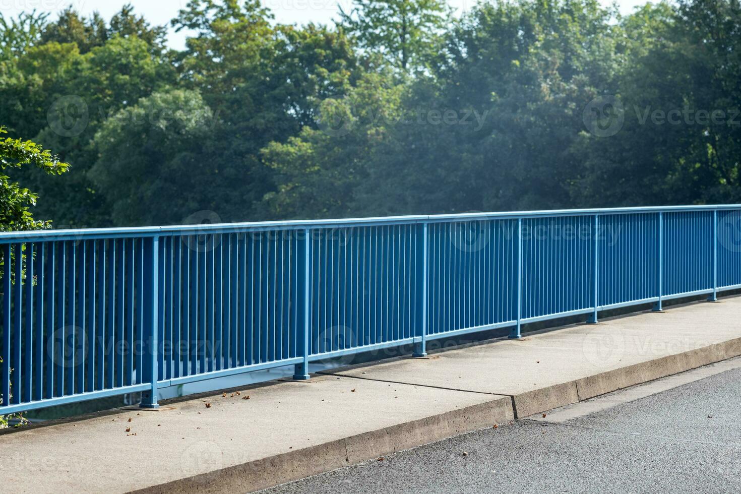 blue bridge railing in the sun photo