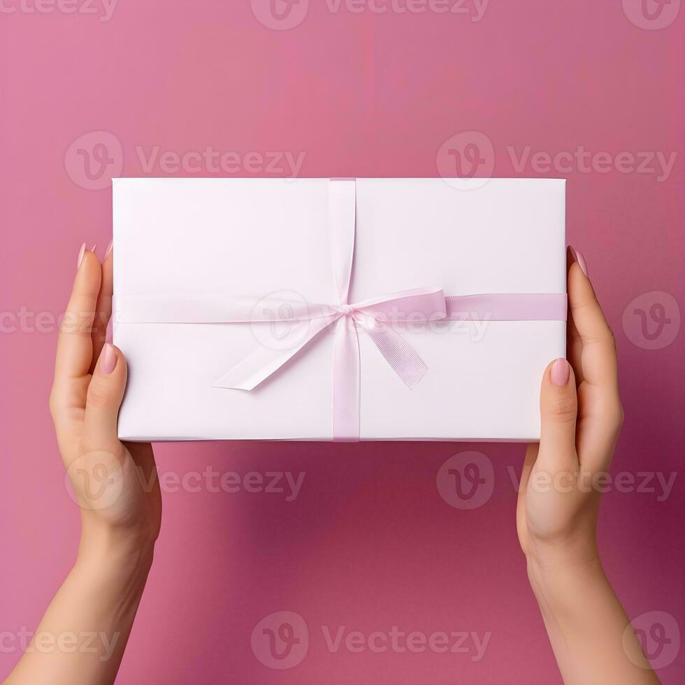 AI generated Hands Holding a Gift Box with Pink Ribbon on Pink Background photo