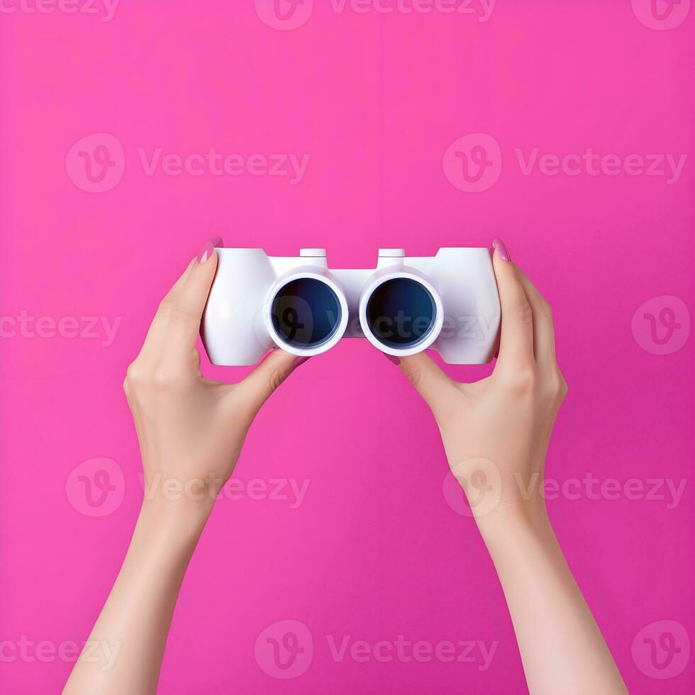 AI generated Hands Holding White Binoculars Against Pink Background photo