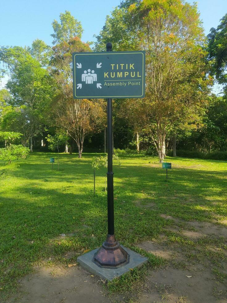 a signpost indicating the gathering point on the grass photo