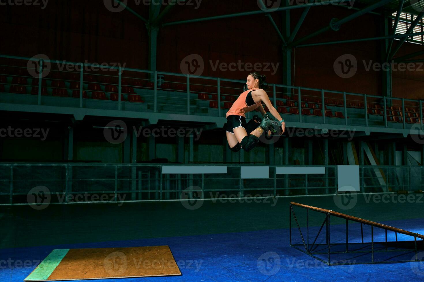 The young woman performs a trick. Jump. Indoor training photo