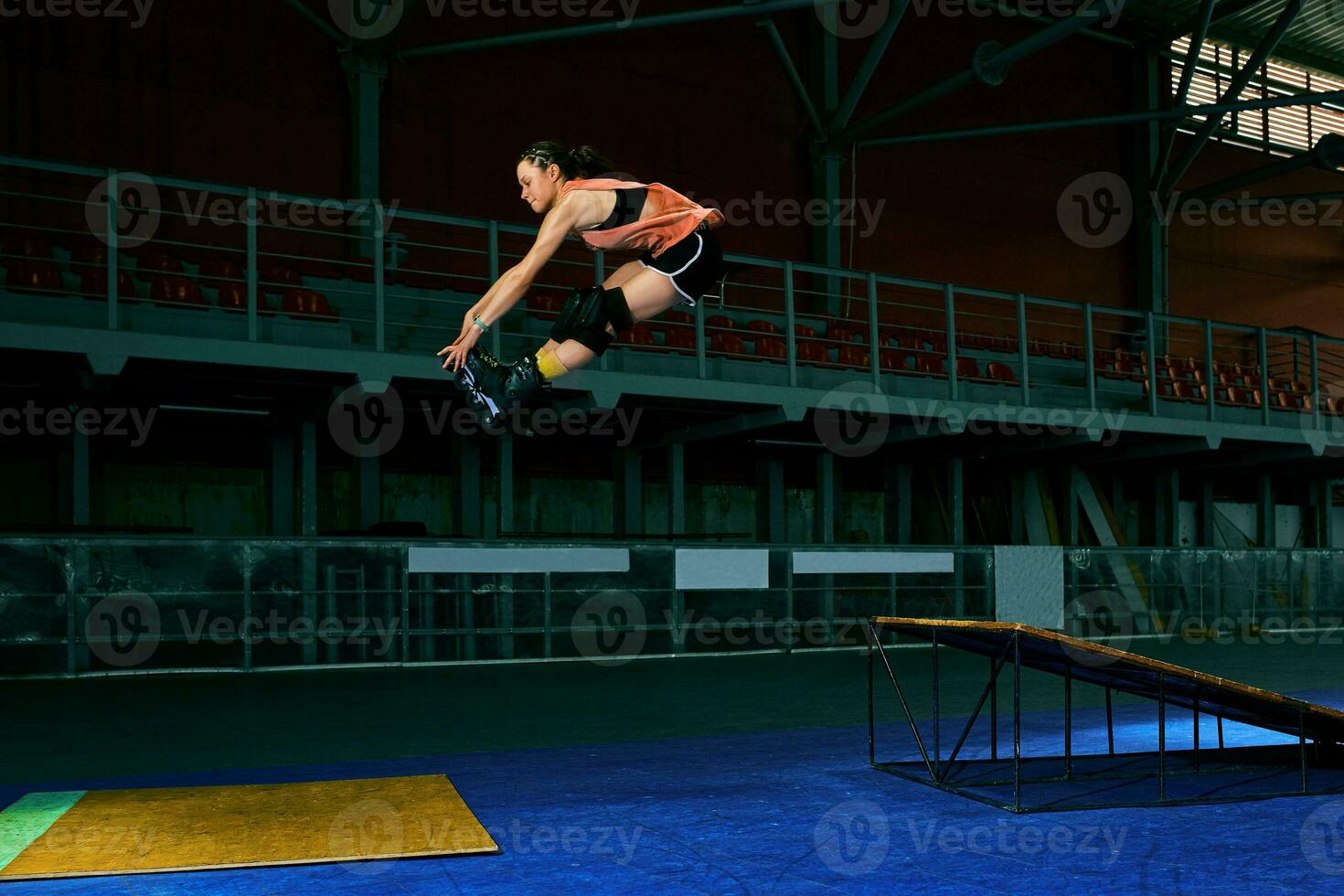 The young woman performs a trick. Jump. Indoor training photo
