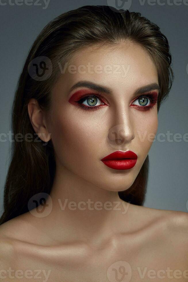 Close-up portrait of a beautiful fashion model with professional make-up. photo