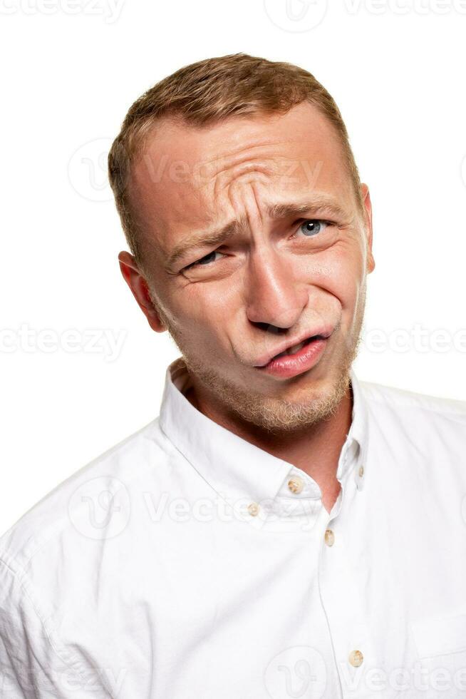 Handsome young blond man in a white shirt, isolated on a white background photo