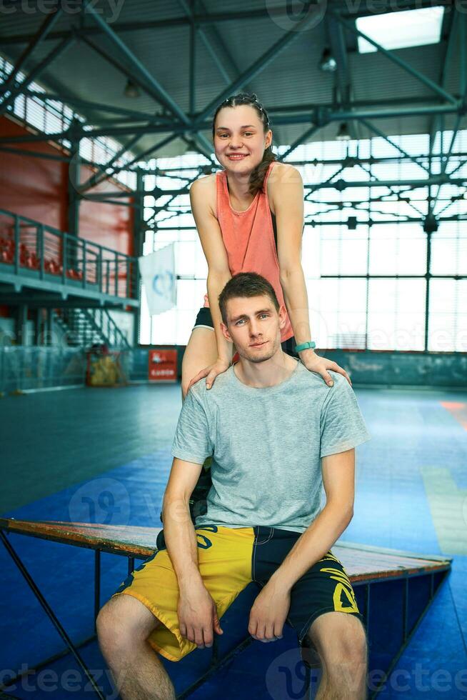 Girl and boy on rollerblades in skate park photo