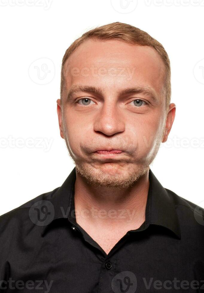 Handsome young blond man in a black shirt, isolated on a white background photo