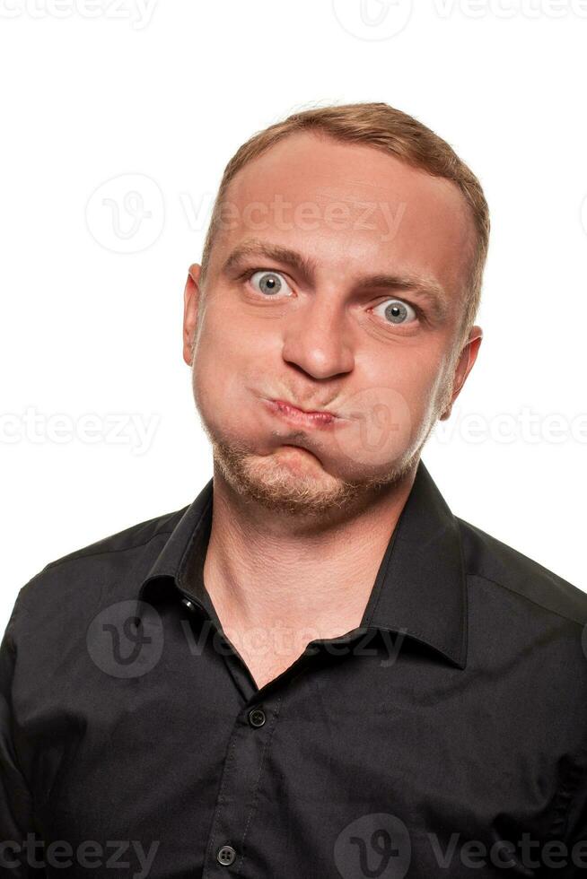 Handsome young blond man in a black shirt, isolated on a white background photo