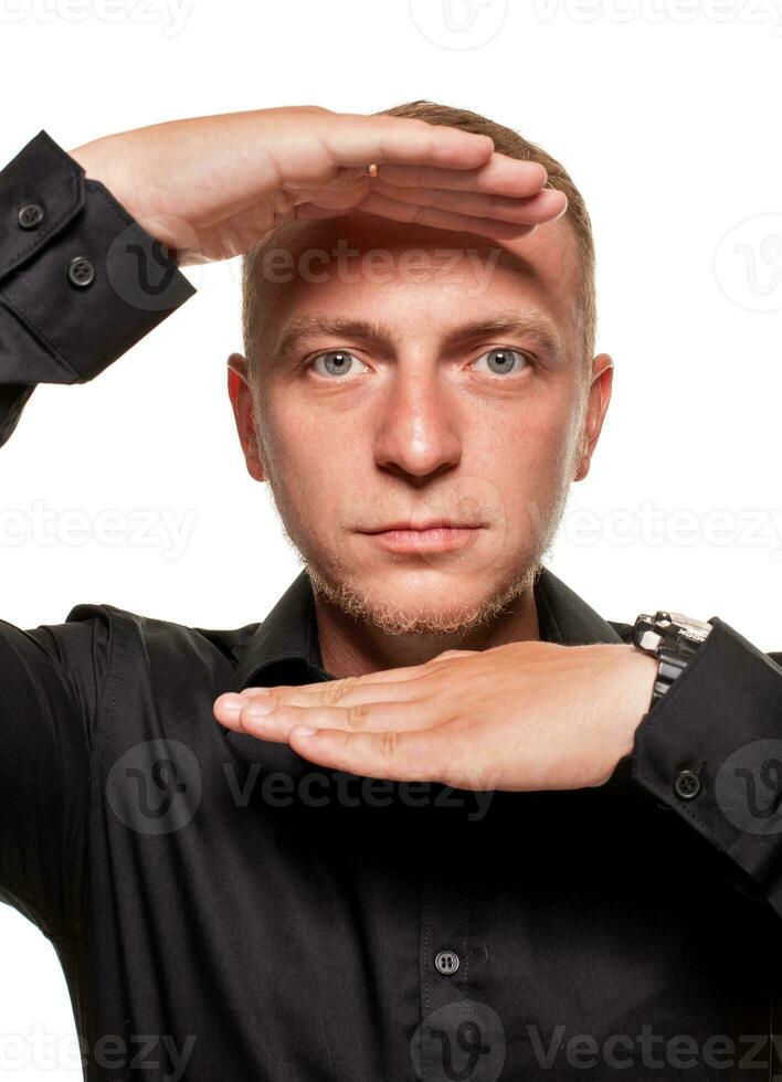 Handsome young blond man in a black shirt, isolated on a white background photo