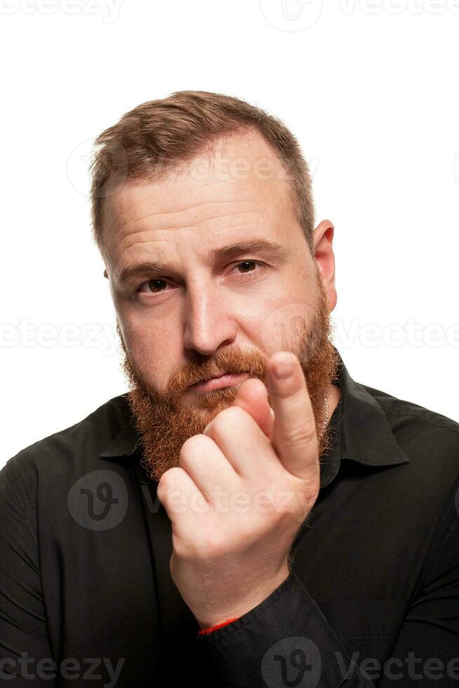 Portrait of a young, chubby, redheaded man in a black shirt making faces at the camera, isolated on a white background photo