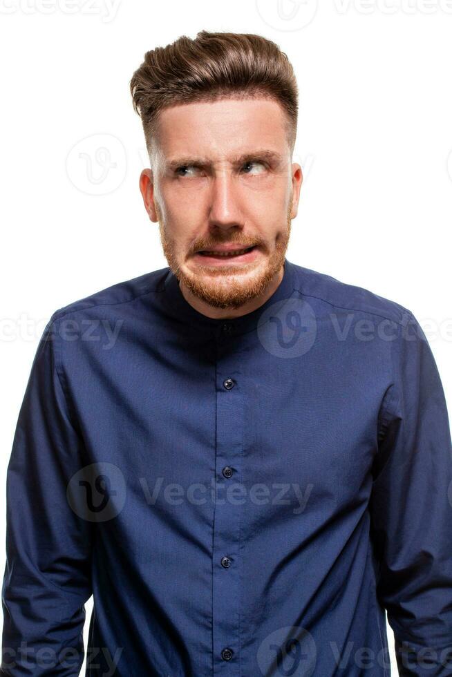 Attractive young man wearing blue shirt, isolated over a white background. photo