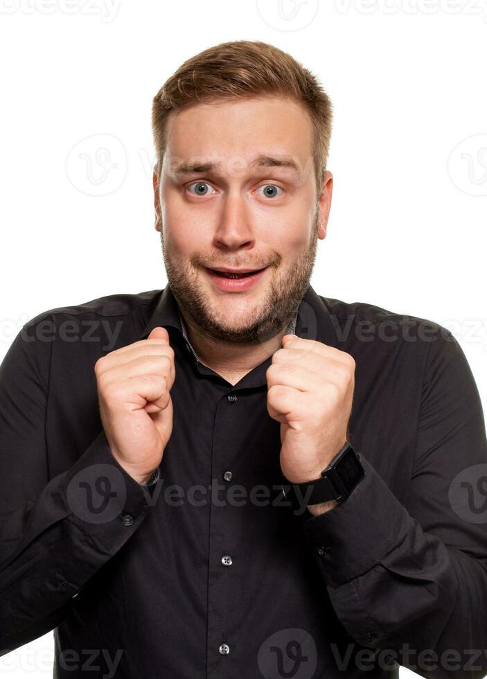 Emotion, advertisement and people concept - surprised man in black shirt over white background photo