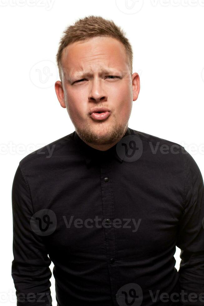 Close up portrait of a confident, blond, handsome young man wearing black shirt, isolated on white background photo