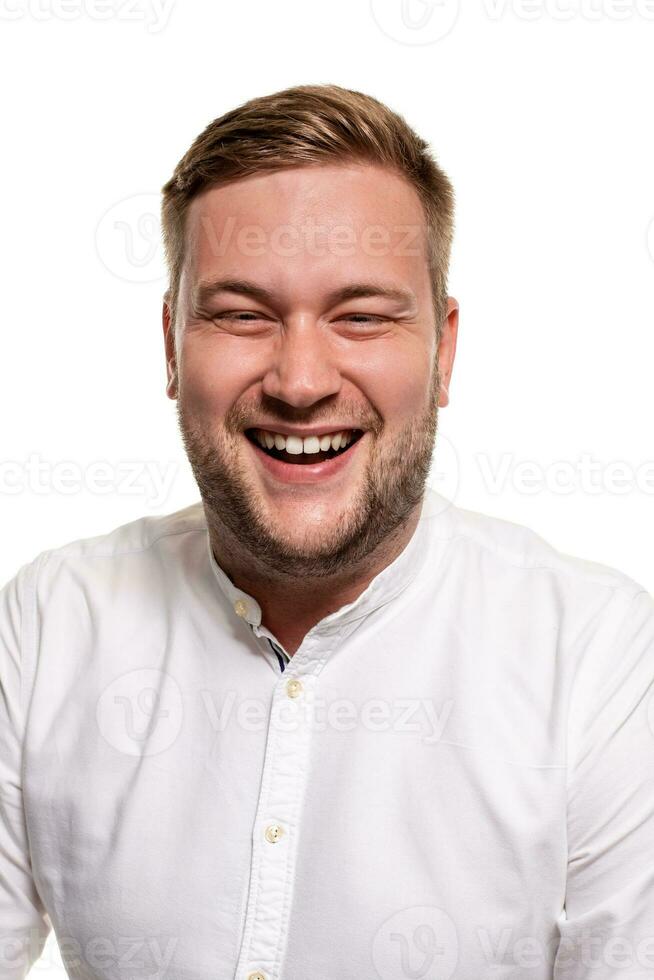 Close up horizontal portrait of a handsome man with a beard, stylish haircut, wearing a white shirt, isolated on a white background photo