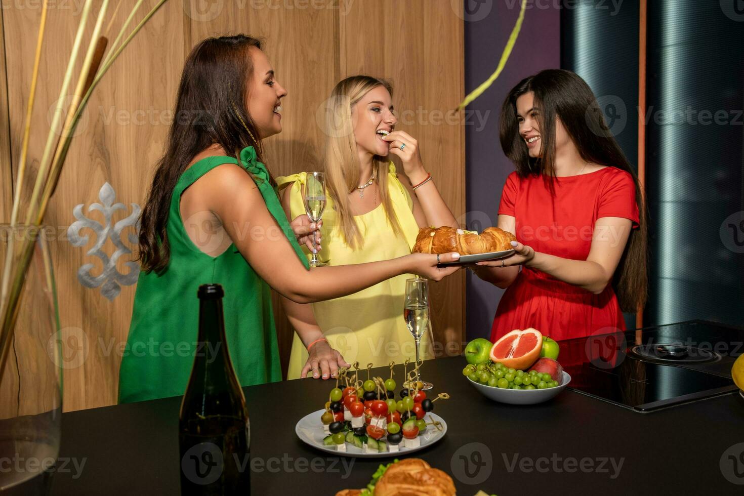 Young carefree girls friends having fun together at house party photo